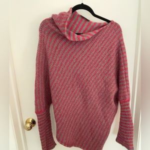 Pink and grey striped turtleneck sweater.